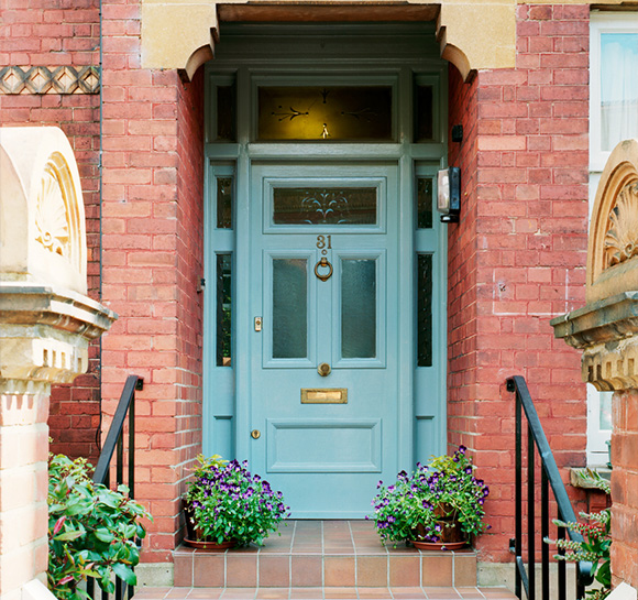 blue front door with plants and steps red brick exterior house number 81 welcoming entryway eight unique design elements